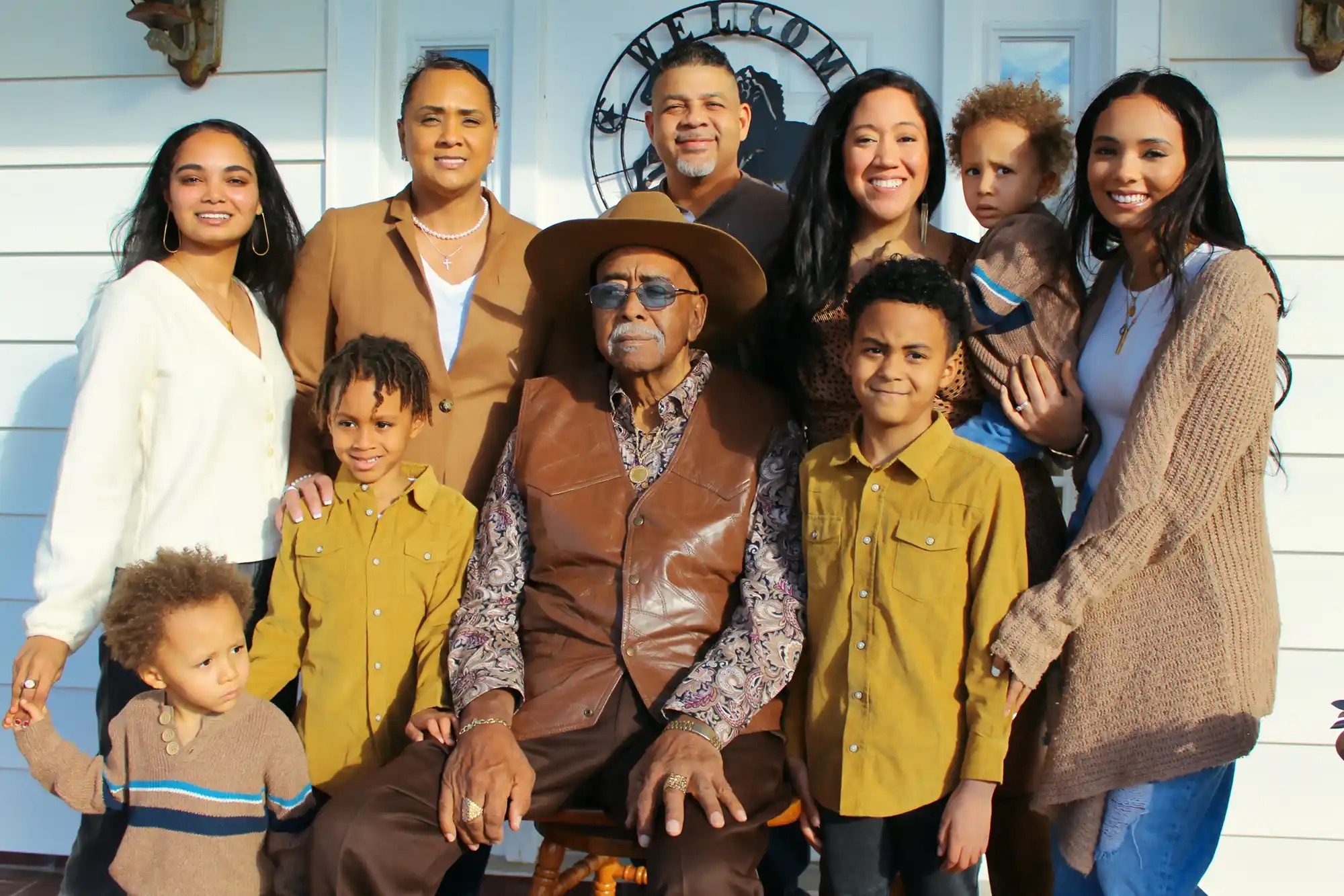 Giant family portrait, showing three or four generations of people with the grandpa in the middle. Showing legacy.
