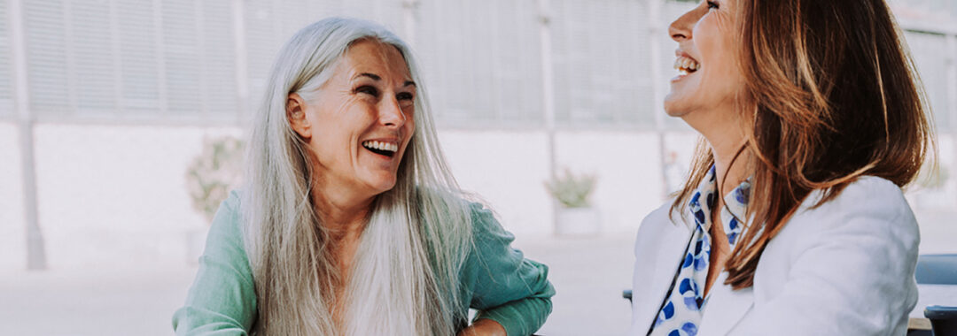 Beautiful senior women meeting outdoors in the city