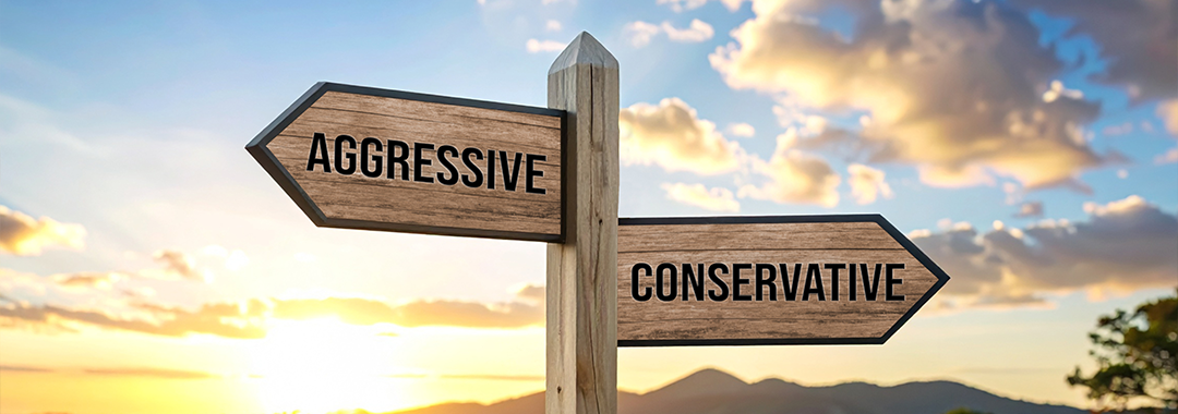A directional sign that shows two paths: aggressive investing and conservative investing
